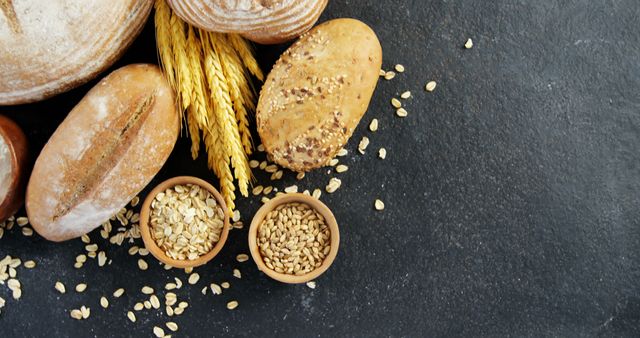 Artisan Bread Selection with Grains on Dark Slate Background - Download Free Stock Images Pikwizard.com