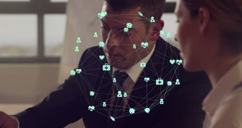 Network of Digital Icons Hovering Over Business Discussion