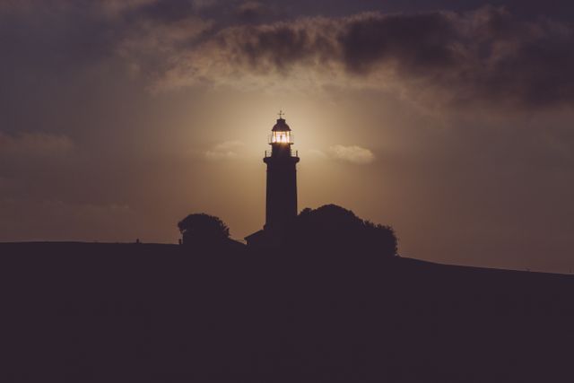 Silhouette of Light House Under Gray Dark Sky - Download Free Stock Photos Pikwizard.com