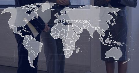 Female Executives Collaborating on Global Strategy Featuring World Map Overlay in Boardroom