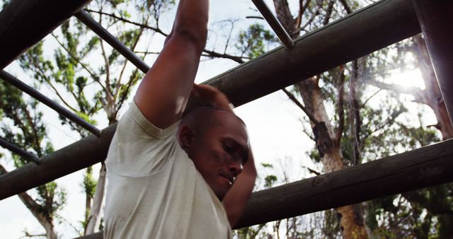 Man Exercising on Outdoor Monkey Bars in Forest Setting - Download Free Stock Images Pikwizard.com