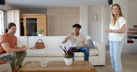 Friends Socializing with Refreshing Drinks in Cozy Living Room