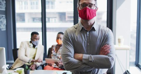 Confident Professional Wearing Face Mask in Modern Office