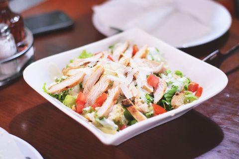 Grilled Chicken Caesar Salad Featuring Roma Tomato, Shaved Parmesan and Creamy Dressing