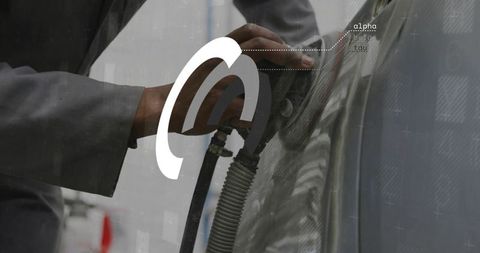 Technician refueling vehicle holding fuel nozzle with ribbed hose and metallic reflection
