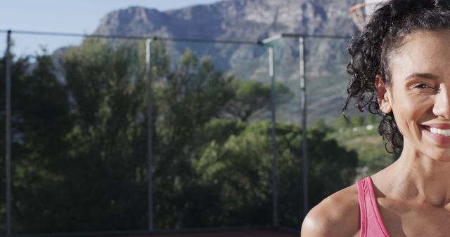 Smiling Woman Exercising Outdoors with Mountain Landscape in Background - Download Free Stock Images Pikwizard.com