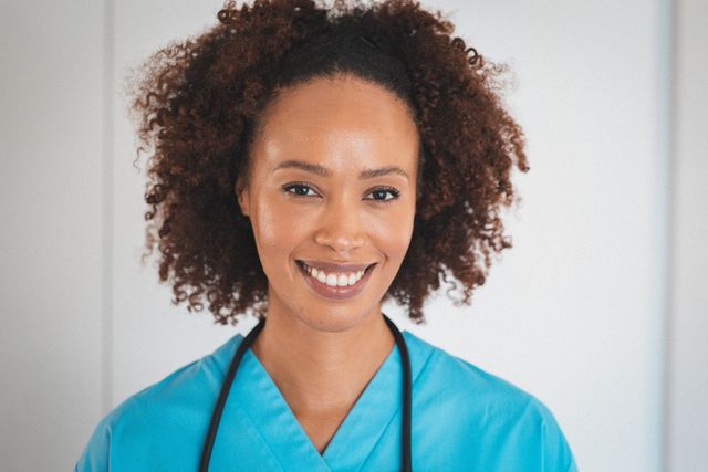 Portrait of happy biracial female doctor with stetoscope smiling. professional healthcare worker during workday.