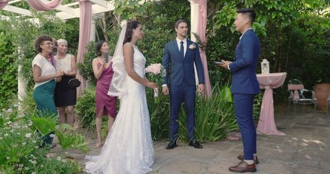 Bride and groom exchanging vows in outdoor ceremony