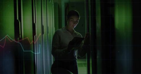 It technician analyzing data on tablet in high-tech data center