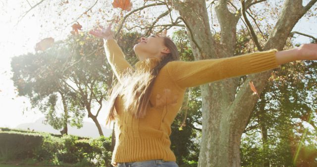 Woman Enjoying Time in Nature with Autumn Leaves - Download Free Stock Images Pikwizard.com