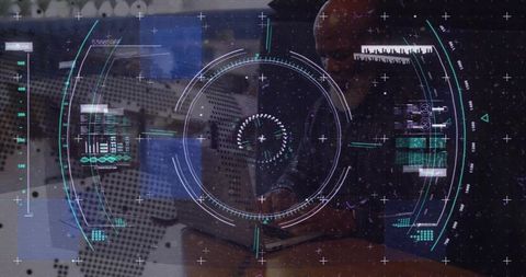 Mature man typing on laptop with futuristic hud data visualization and analytics overlay