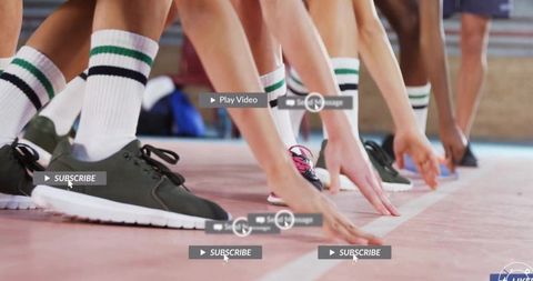 Athletes pushing off starting line close-up sneakers striped socks sprint team competition