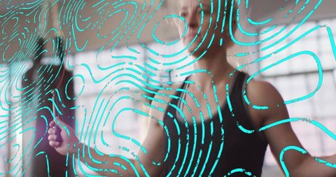 Midlife woman touching glass panel during gym workout with turquoise graphic overlay