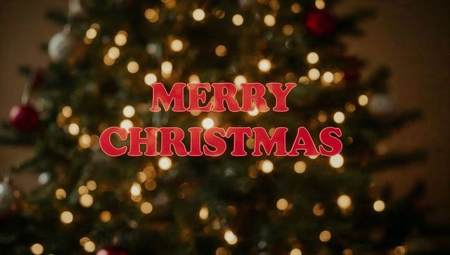 Merry christmas red serif text over bokeh christmas tree with warm ornaments and cozy glow