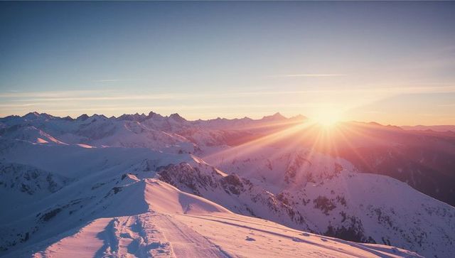 Majestic Sunrise Over Snow-Covered Alpine Ridge