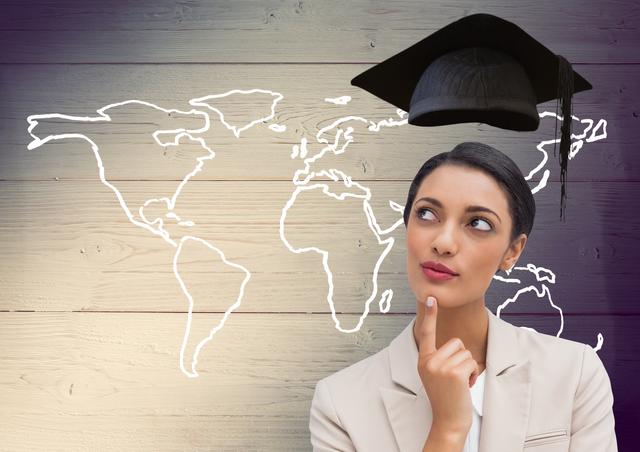 Image features a businesswoman contemplating with a floating graduation cap and a world map drawn on wooden background. Perfect for representing concepts of global education, career planning, professional development, and future success. Suitable for websites, educational materials, and career counseling resources.