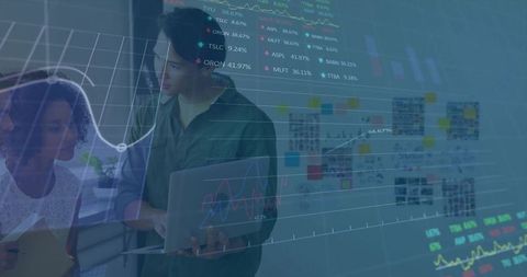 Asian professional analyzing laptop dashboard with projected analytics and collaboration