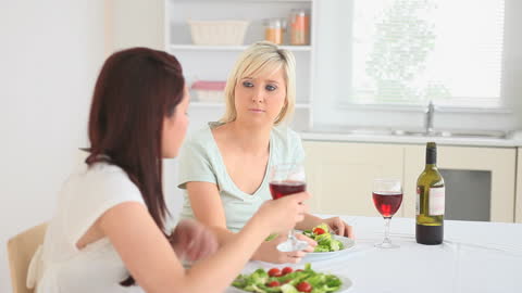 Friends Enjoying Wine and Salad in Modern Kitchen