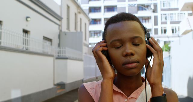 Young Person Enjoying Music While Walking Outdoors - Download Free Stock Images Pikwizard.com