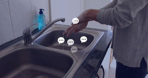 Person washing hands in kitchen sink demonstrating cleanliness