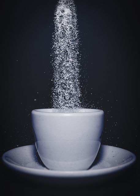 Sugar Pouring into White Cup on Saucer in Dark Background - Download Free Stock Photos Pikwizard.com