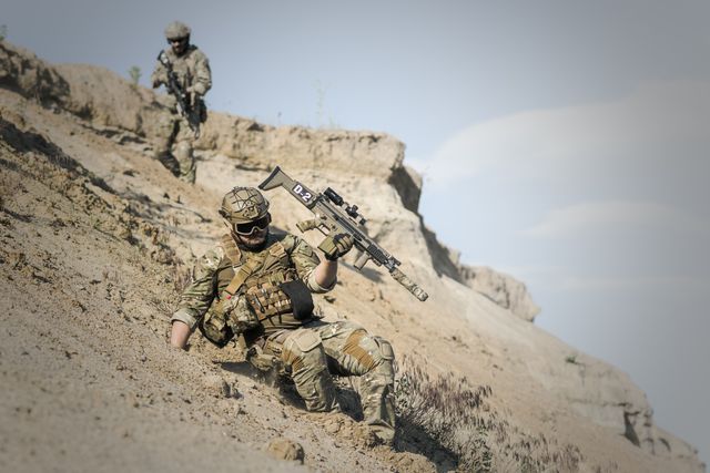 Soldiers Traversing Rocky Hillside in Full Tactical Gear - Download Free Stock Photos Pikwizard.com