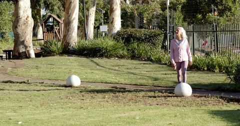 Senior Woman Enjoying Walk Through Tranquil Nature Path