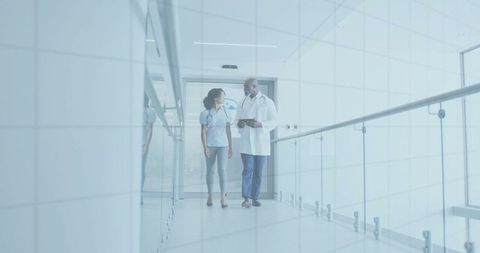 Healthcare Professionals Discussing in Modern Hospital Corridor
