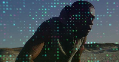 Athletic man on beach with digital pixel overlay depicting technology