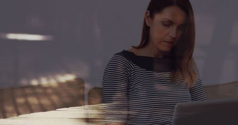 Businesswoman Using Laptop with Urban Environment Overlay
