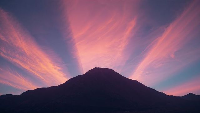 Mountain Silhouette with Radiant Pink-Orange Morning Sky