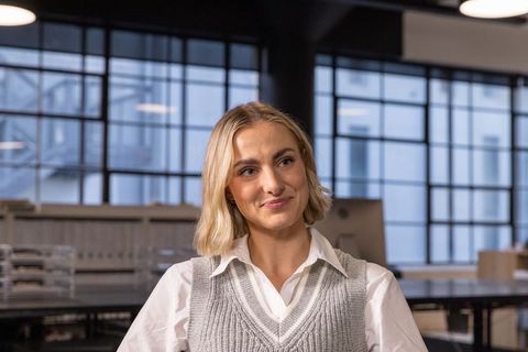 Professional Woman Engages with Colleague in Modern Open Plan Office