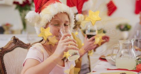 Festive christmas dinner with family wearing santa hats