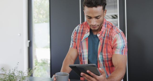 Young Man Using Tablet While Having Breakfast - Download Free Stock Images Pikwizard.com