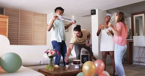 Friends Celebrating With Cake and Balloons at Home Party