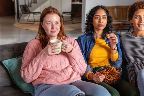 Diverse Women Relaxing Together with Snacks in Cozy Living Room