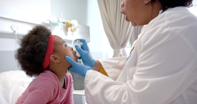 Pediatric Doctor Examining Child with Reflective Headband in Hospital - Download Free Stock Images Pikwizard.com