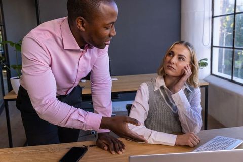 Diverse Coworkers Discussing Business at Modern Office Desk