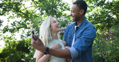 Happy couple celebrating engagement in vibrant garden