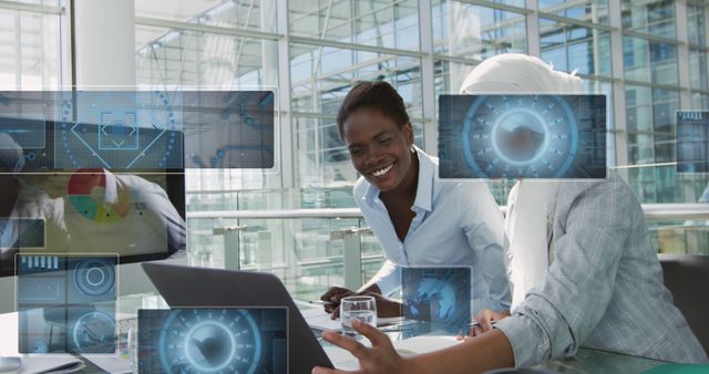 Businesswomen Analyzing Futuristic Data on Laptops in Modern Office - Download Free Stock Images Pikwizard.com