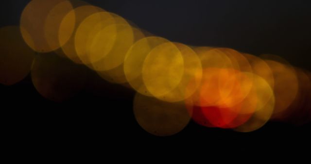 Spots of yellow and red bokeh lights blinking against black background - Download Free Stock Photos Pikwizard.com
