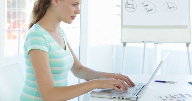 Young Woman Typing on Laptop in Bright Office Space - Download Free Stock Images Pikwizard.com