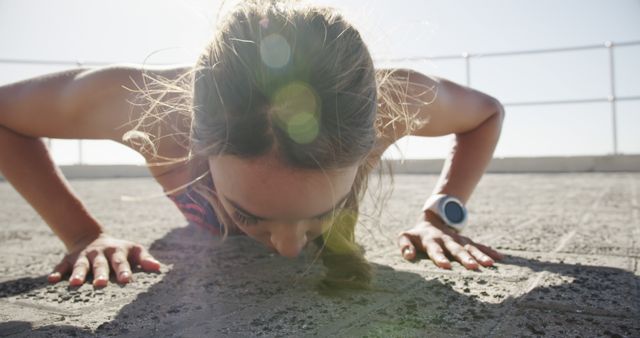 Determined Woman Doing Push-Ups Outdoors on Sunny Day - Download Free Stock Images Pikwizard.com