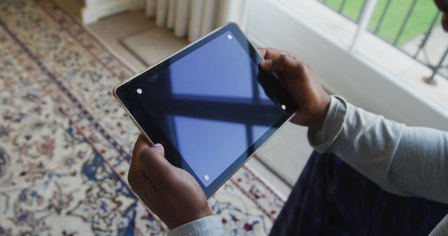 Person holding tablet with blank screen while sitting indoors - Download Free Stock Images Pikwizard.com