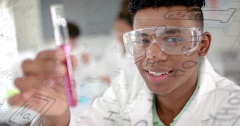 Young scientist in laboratory with focus on data processing