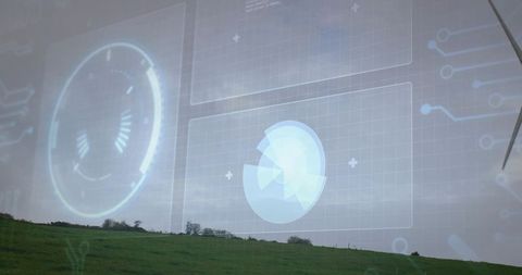 Futuristic renewable energy monitoring over green hillside with hud overlay