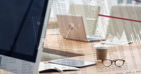 Business workspace with live data overlay showing laptop tablet coffee glasses on wood desk