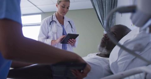 Doctor and Nurse Checking Patient's Vitals in Hospital Room