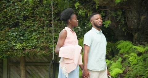Joyful Young Couple Dancing Outdoors on Sunny Day