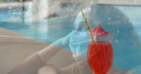 Summertime Beverage Beside Pool with Masked Woman Reflecting - Download Free Stock Images Pikwizard.com